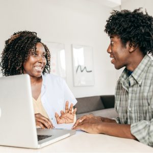 Two individuals collaborating at a computer