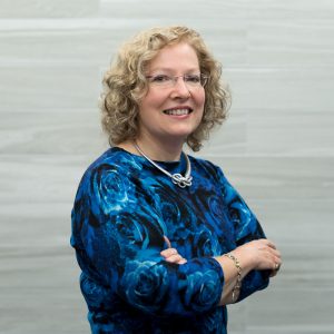 Woman crossing arms smiling at camera