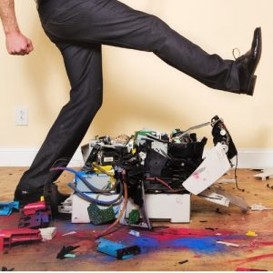Man stepping on broken fax machine