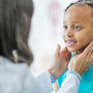 Doctor checking patient's throat
