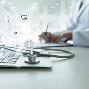 Doctor with computer and stethoscope at desk