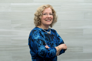 Woman crossing arms smiling at camera