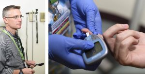 Doctor taking finger prick blood sample