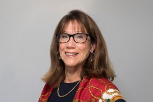 Woman with glasses smiling at camera
