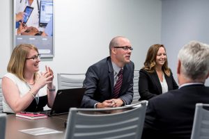 Team members sitting around table talking