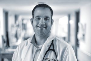 Doctor smiling at camera black and white