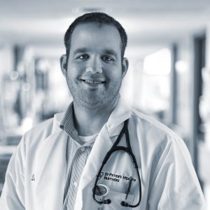 Doctor smiling at camera black and white