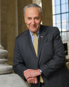 Man leaning on wall smiling at camera