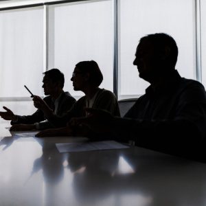 Silhouettes sitting around a table