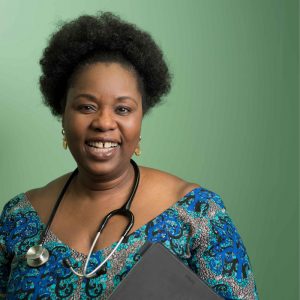 Woman with stethoscope around neck smiling at camera