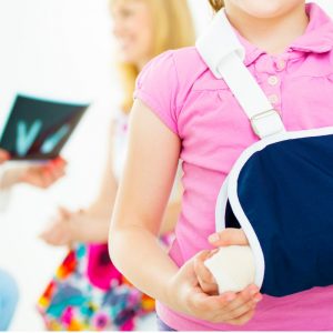 Young girl with broken arm and doctor speaking with mother in background