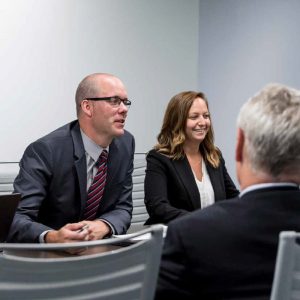 Team members sitting around table talking