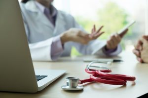 Doctor speaking with computer and stethoscope