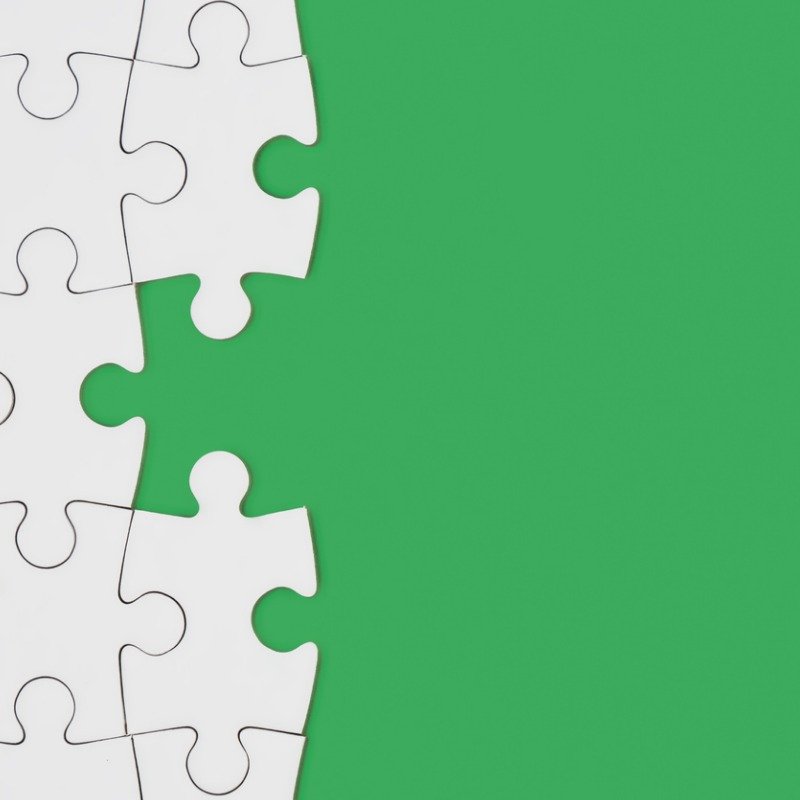 Green background with white puzzle pieces