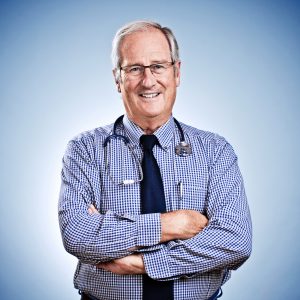 Man in glasses and tie crossing arms looking at camera with stethoscope around shoulders